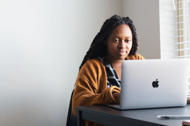A candidate working through her course on a laptop