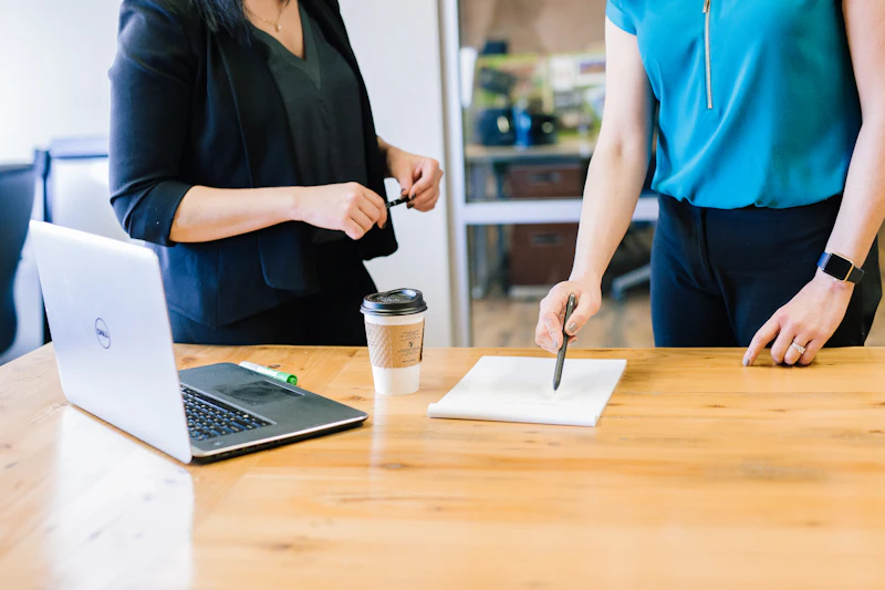Two people reviewing a written document at a desk